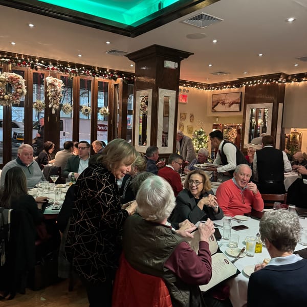 Diners enjoying a festive meal at Pietro's, an Italian restaurant decorated for the holidays.