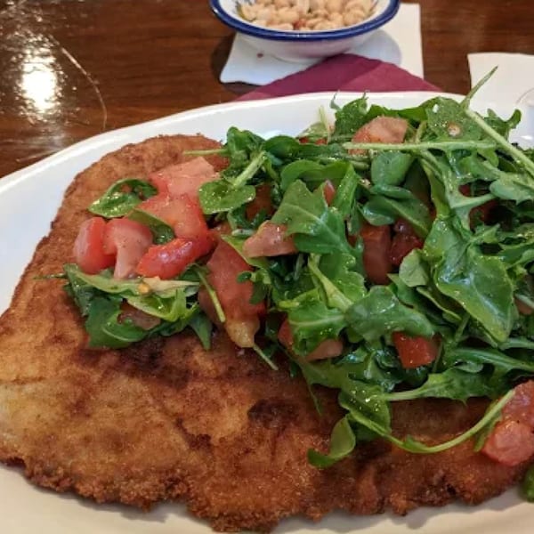 Pietros' large breaded chicken cutlet topped with fresh arugula and diced tomatoes.